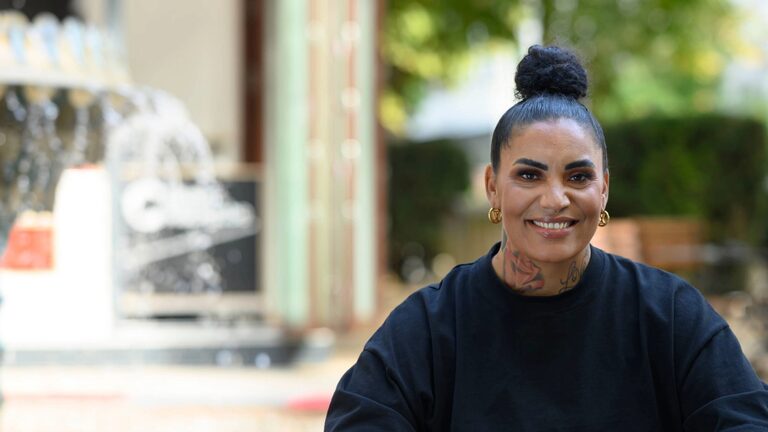 Woman sitting in front of a large fountain